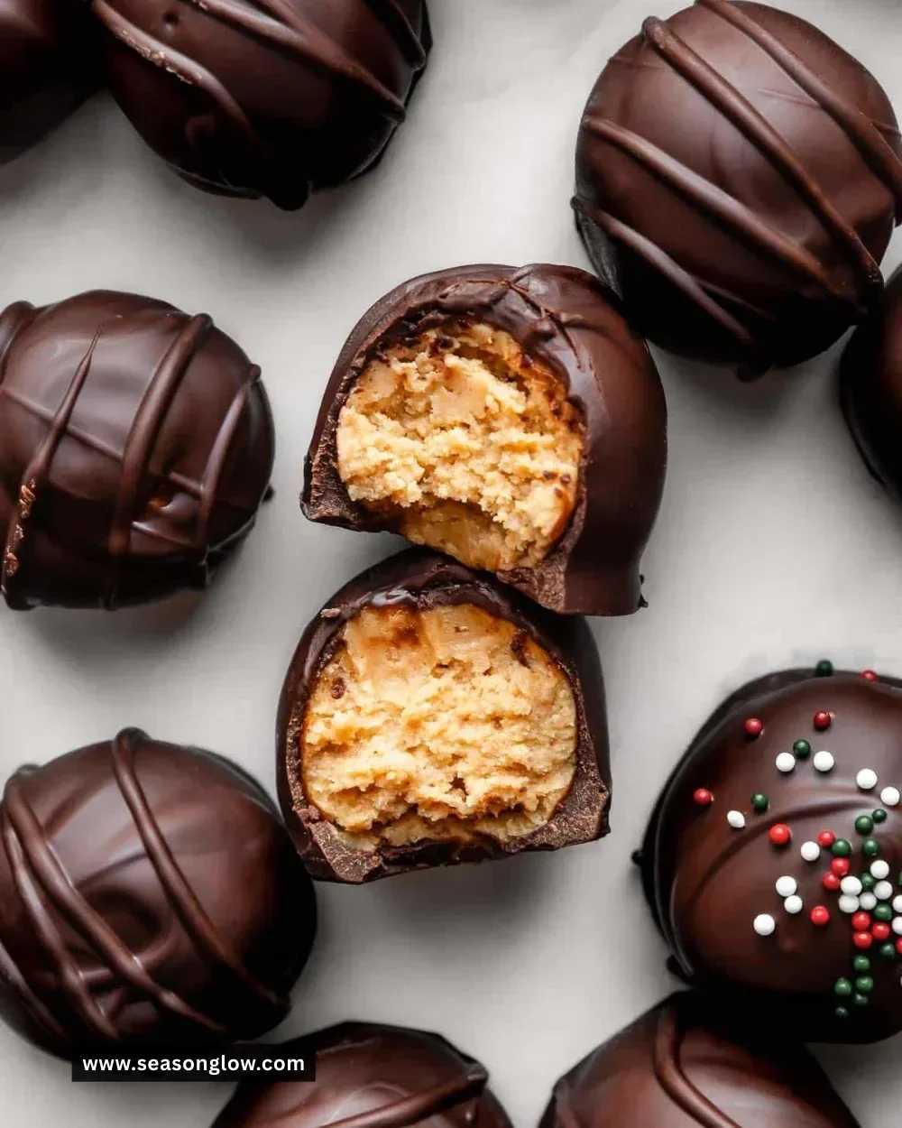 Homemade peanut butter balls truffles coated in chocolate and sprinkled with nuts