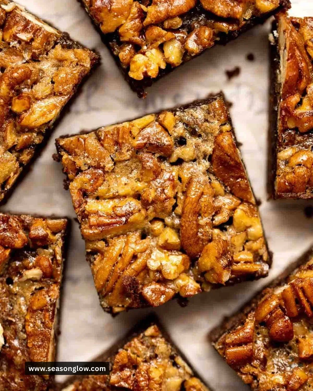 Delicious pecan pie brownies topped with nuts and chocolate drizzle