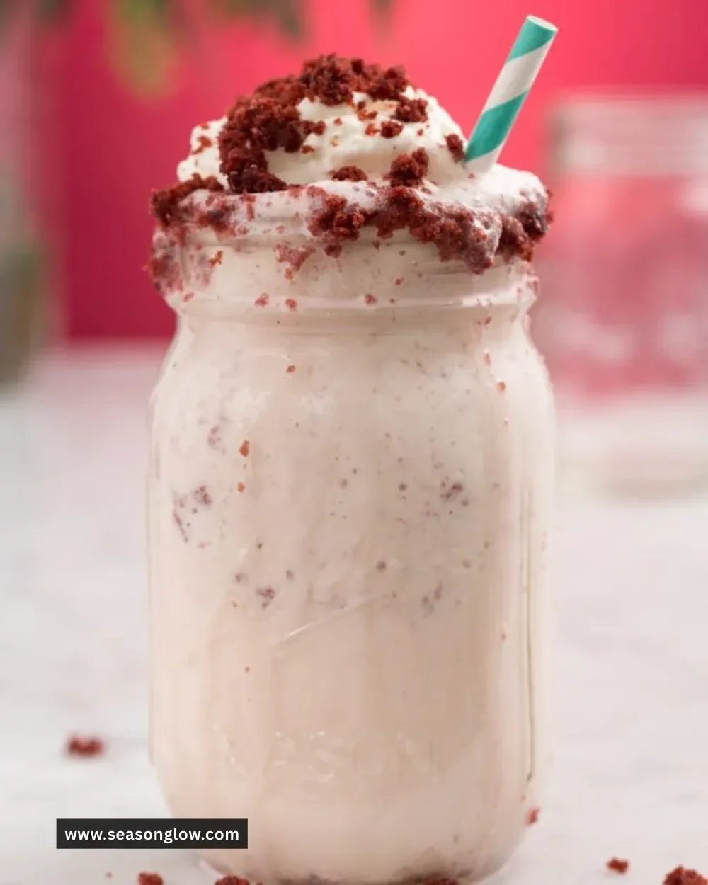 Delicious Red Velvet Cheesecake Milkshake topped with whipped cream and red velvet sprinkles