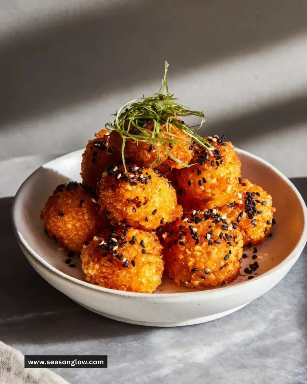 Delicious salmon crispy rice bites topped with fresh ingredients and served on a plate