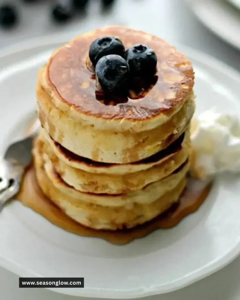 Plate of fluffy Scottish pancakes topped with berries and syrup
