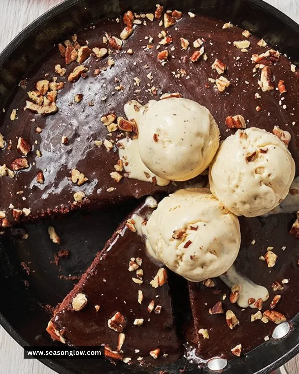 Skillet Texas Sheet Cake topped with chocolate frosting and nuts