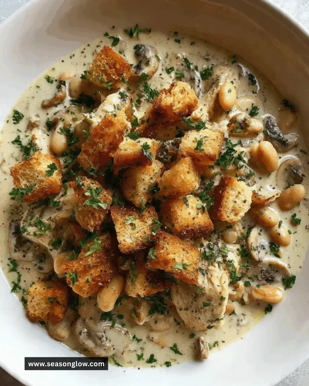 Slow Cooker Garlic Butter Chicken served on a plate garnished with herbs.
