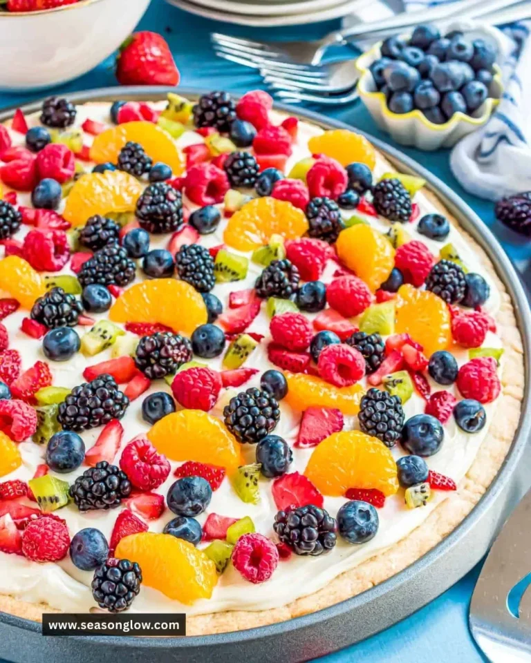 Delicious sugar cookie fruit pizza topped with fresh fruits and creamy frosting