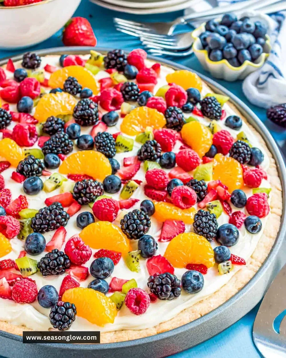 Delicious sugar cookie fruit pizza topped with fresh fruits and creamy frosting