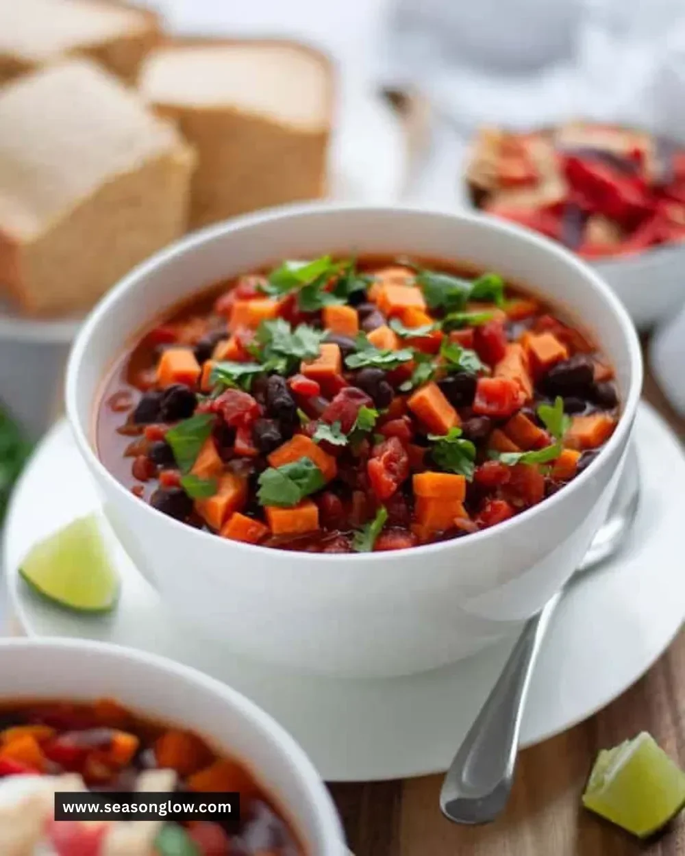 Bowl of delicious Sweet Potato Black Bean Chili topped with fresh herbs
