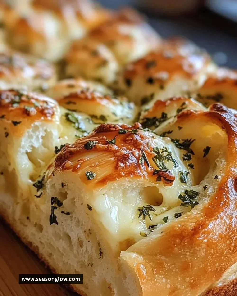 Swirled garlic herb and cheese bread topped with herbs and melted cheese.