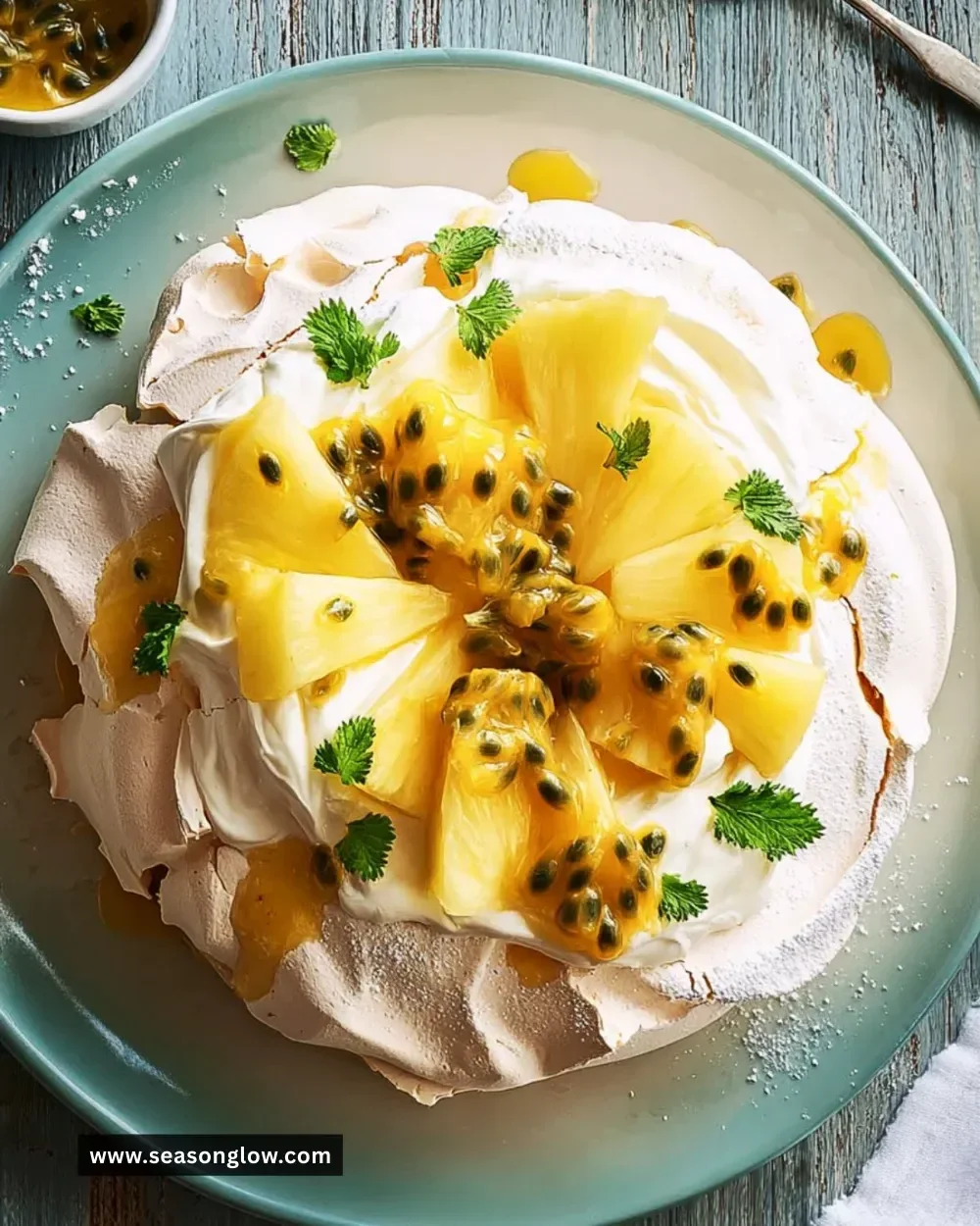 Vanilla Pavlova dessert topped with pineapple and passion fruit