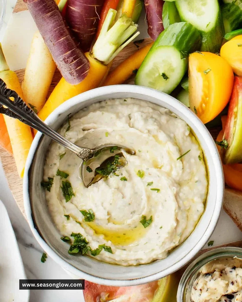 Delicious homemade white bean dip served with fresh vegetables and pita chips
