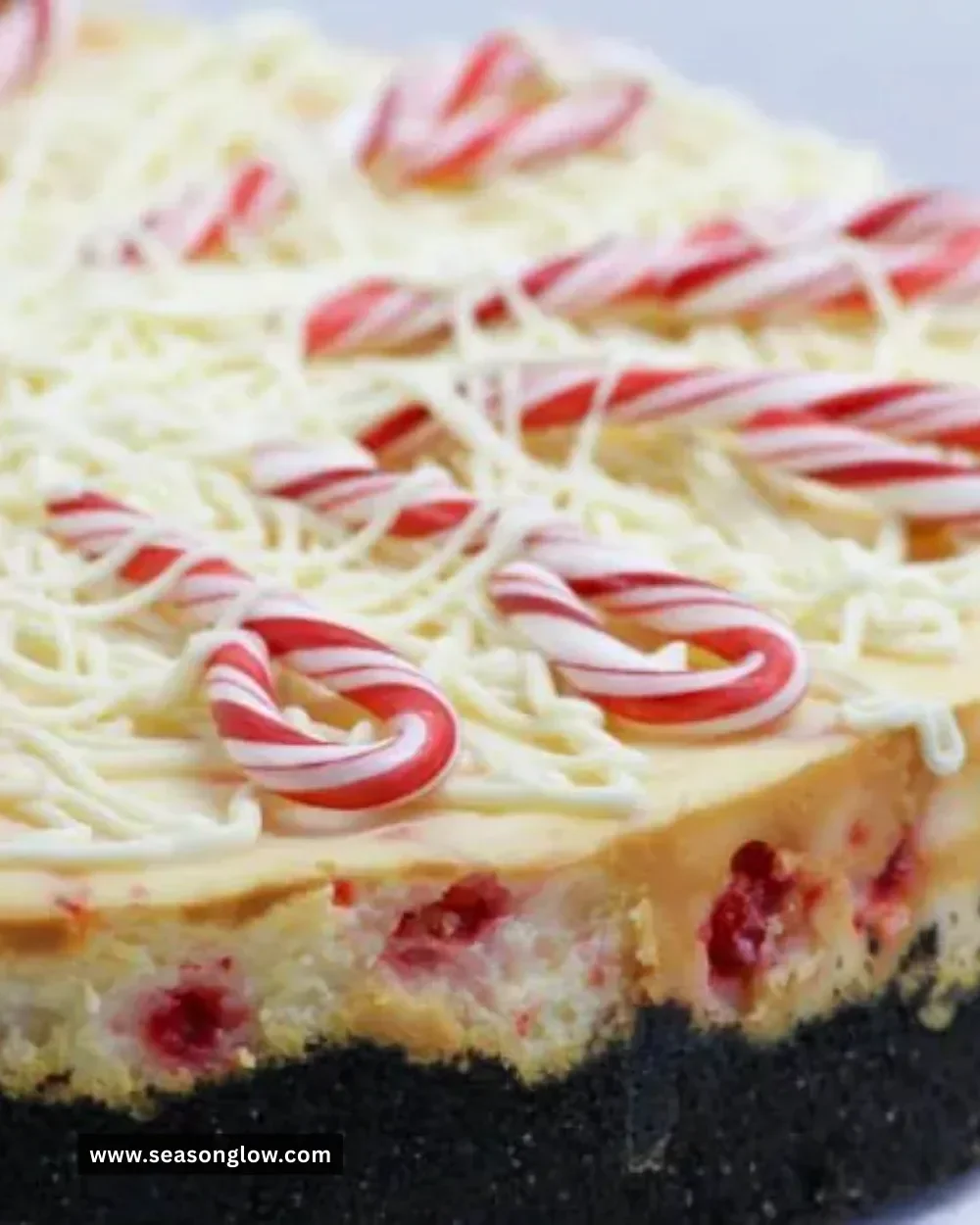 Slice of white chocolate peppermint cheesecake with festive holiday decorations