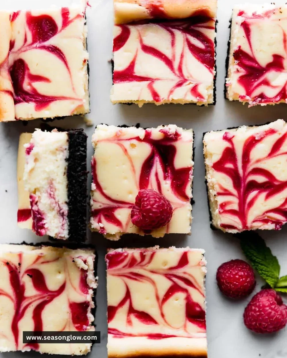 Delicious white chocolate raspberry cheesecake bars served on a plate