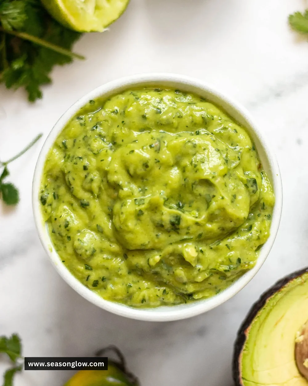 Homemade Avocado Habanero Sauce in a ceramic bowl with fresh ingredients.