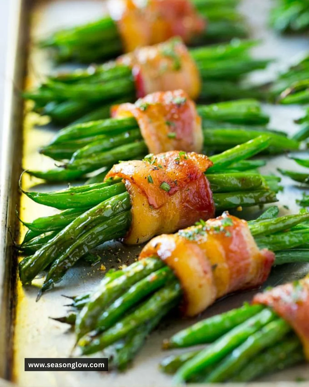 Bacon wrapped green beans on a rustic plate, garnished and ready to serve.