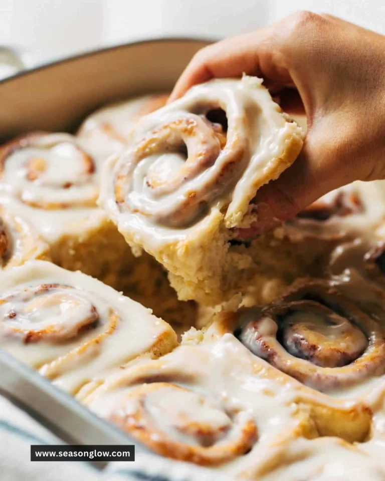 Delicious homemade cinnamon rolls drizzled with icing on a plate