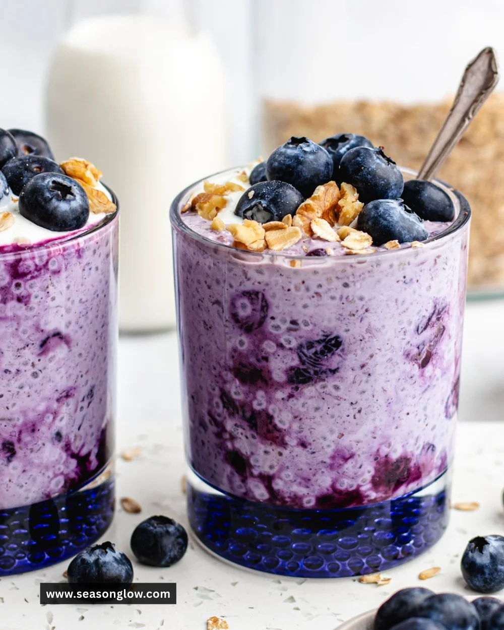Bowl of blueberry overnight oats topped with fresh blueberries and nuts