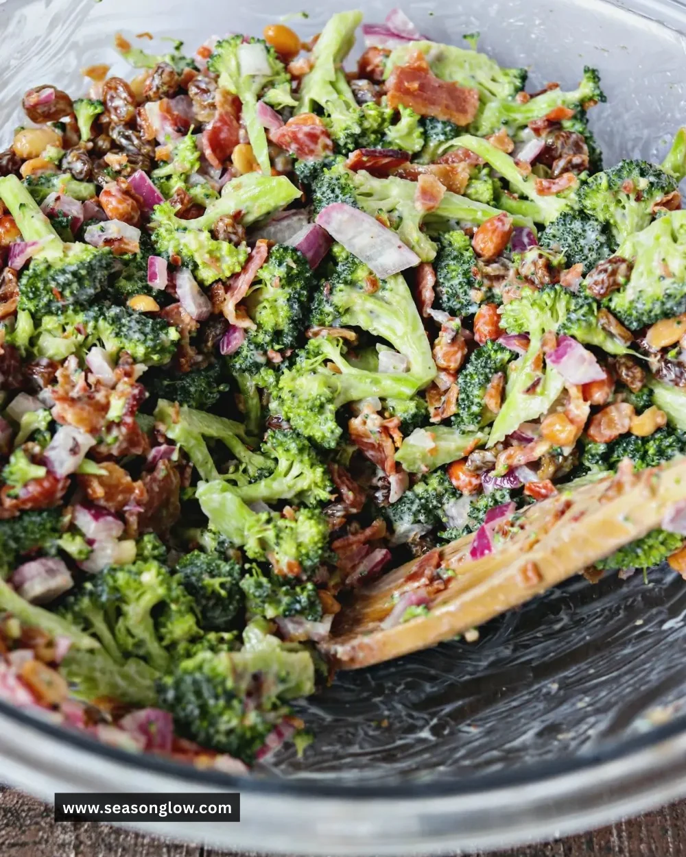 Fresh broccoli salad with crispy bacon, nuts, and dressing in a bowl