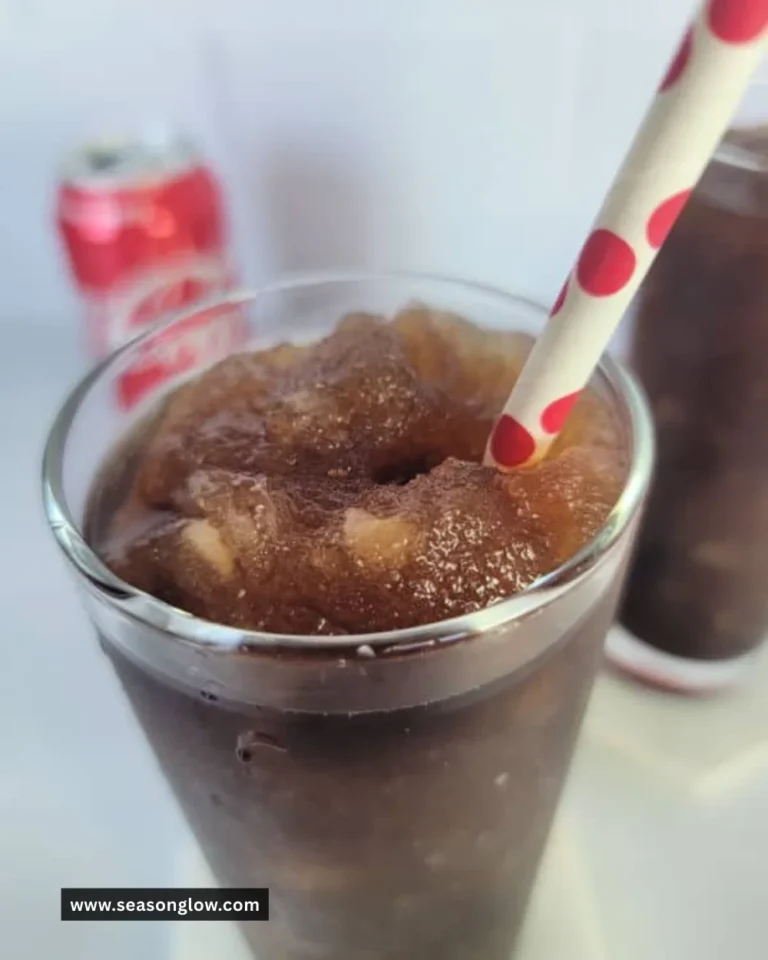 Chilled Coca Cola Slushie in a cup, perfect for summer refreshment.