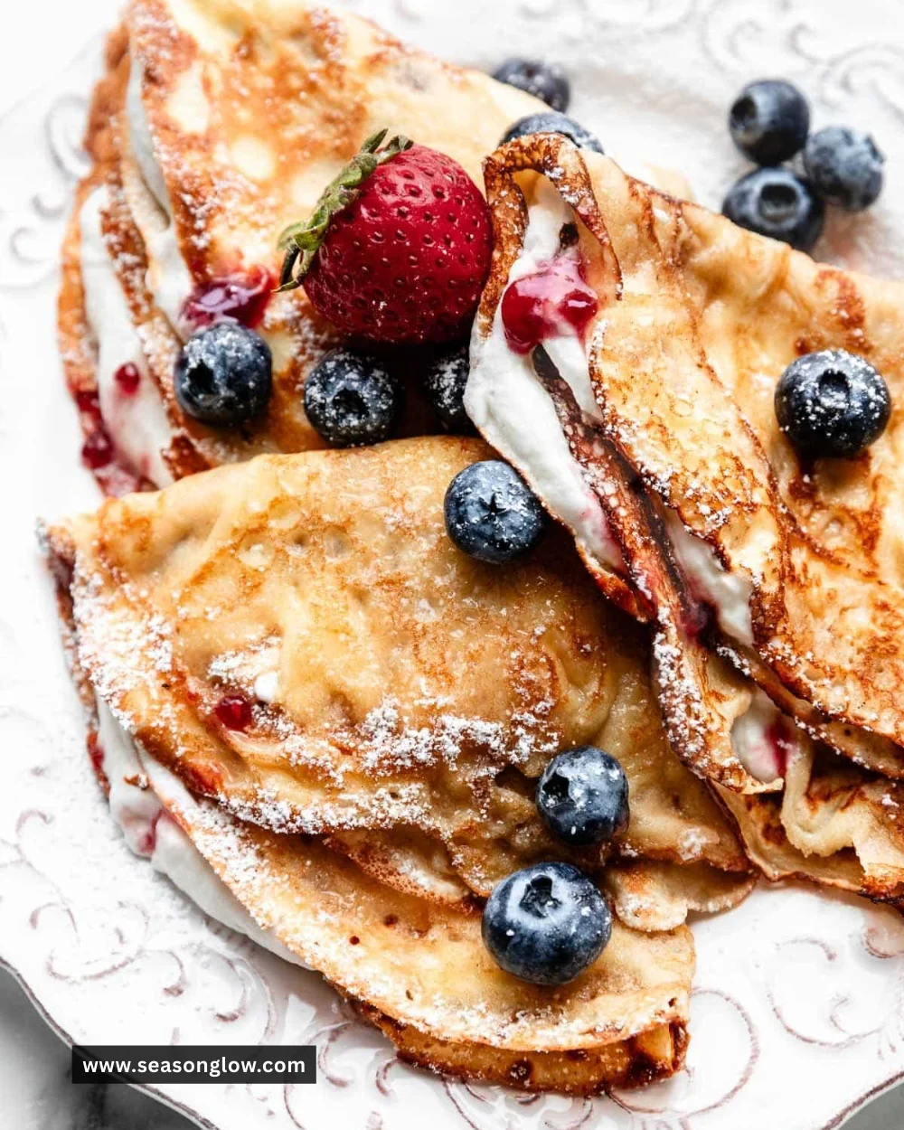 Delicious crepes with various fillings and toppings served on a plate