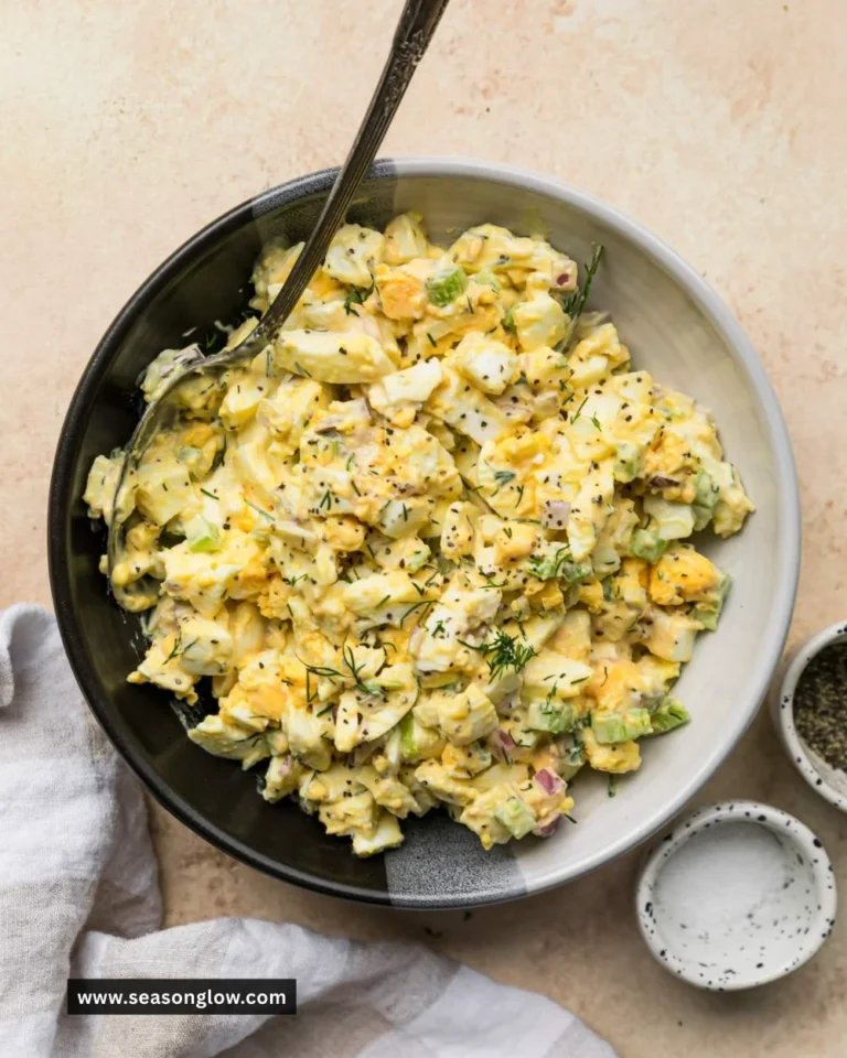 Delicious homemade egg salad served in a bowl with fresh herbs.