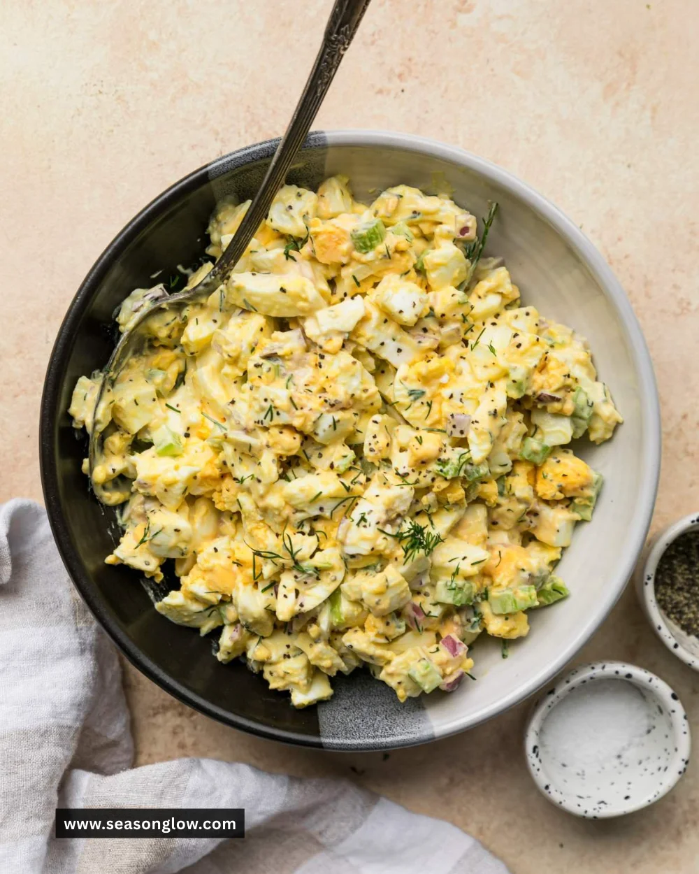 Delicious homemade egg salad served in a bowl with fresh herbs.