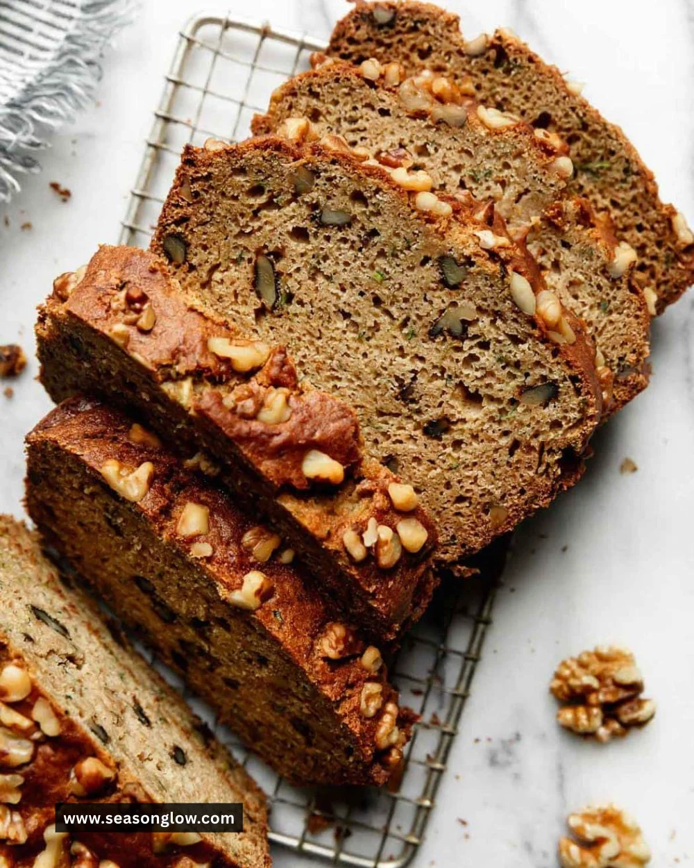 Loaf of gluten-free zucchini bread on a wooden cutting board