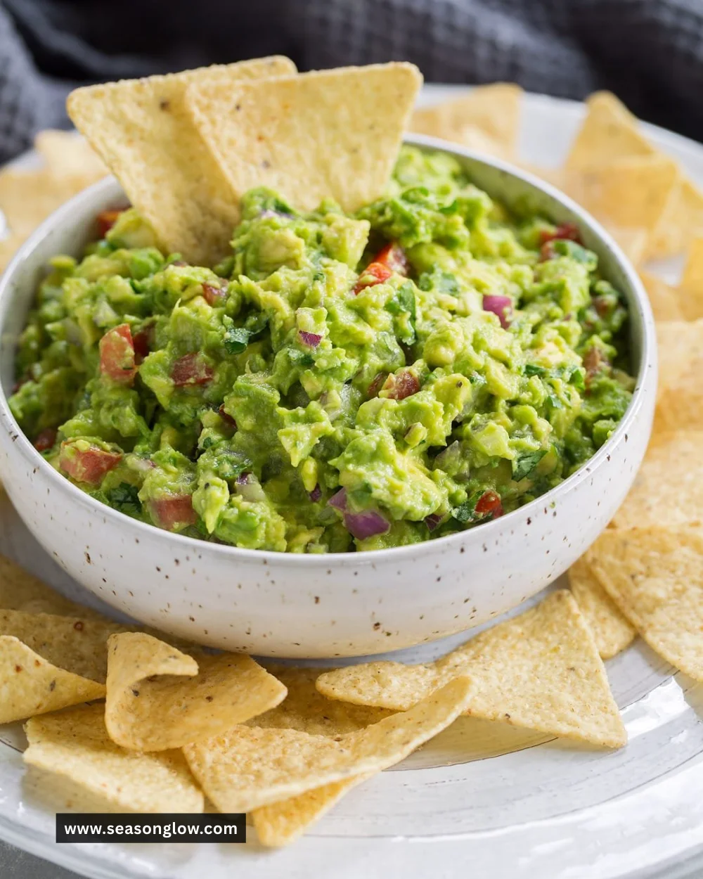 Bowl of homemade guacamole with fresh ingredients