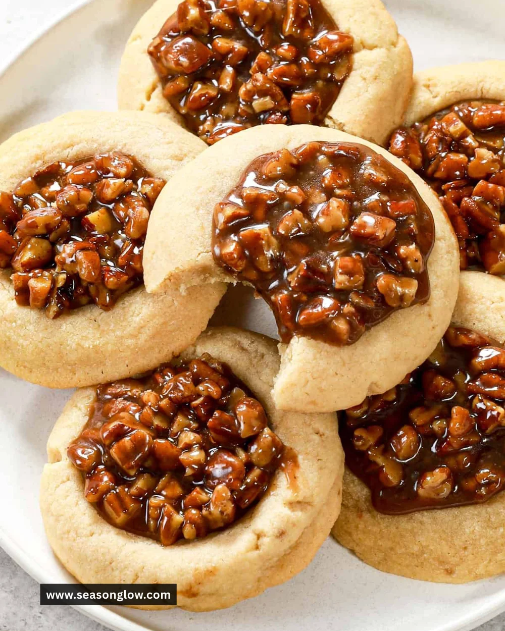 Delicious Pecan Pie Cookies on a cooling rack with chopped pecans on top