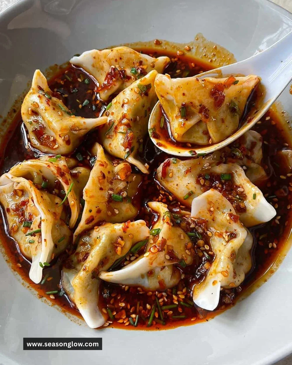Delicious sauce dumplings served in a bowl with dipping sauce.
