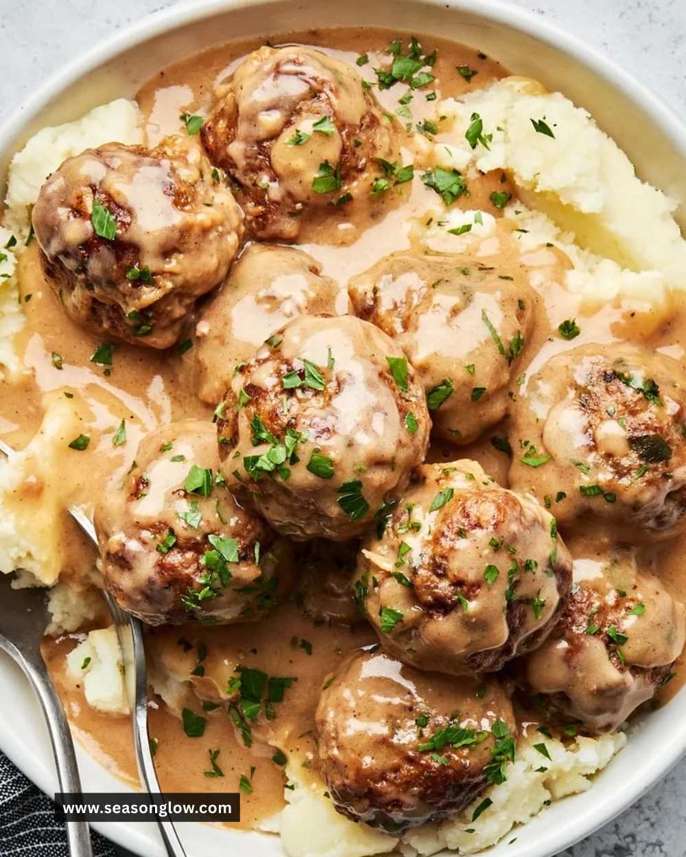 Delicious homemade Swedish Meatballs served with creamy sauce and lingonberries.
