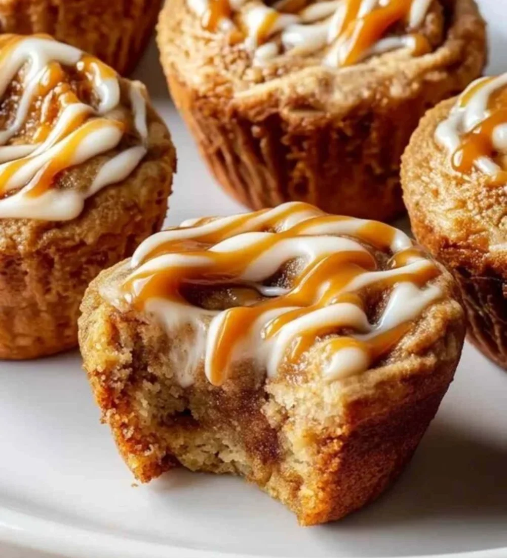 Cinnamon roll protein muffins fresh out of the oven on a kitchen countertop