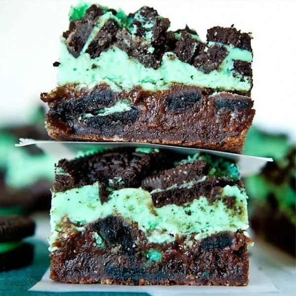 Decadent triple layer mint Oreo brownies on a plate.