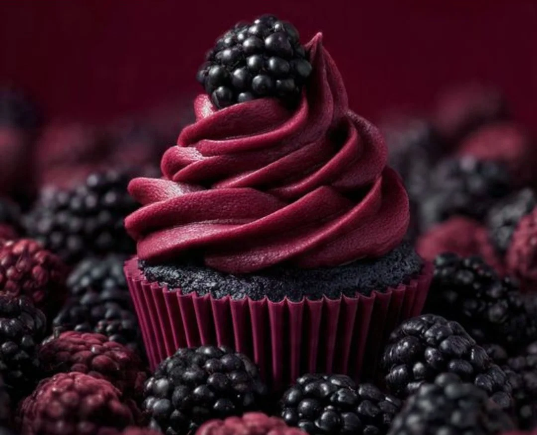 Homemade blackberry buttercream frosting spread on cupcakes