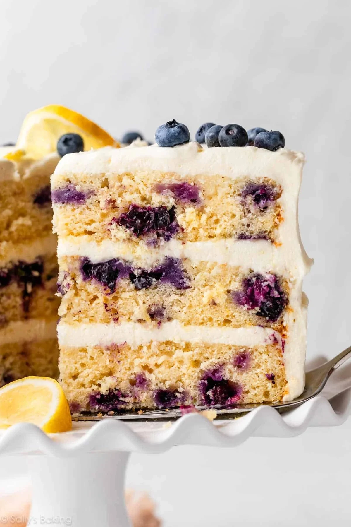 Delicious lemon blueberry layer cake with fresh blueberries and lemon zest