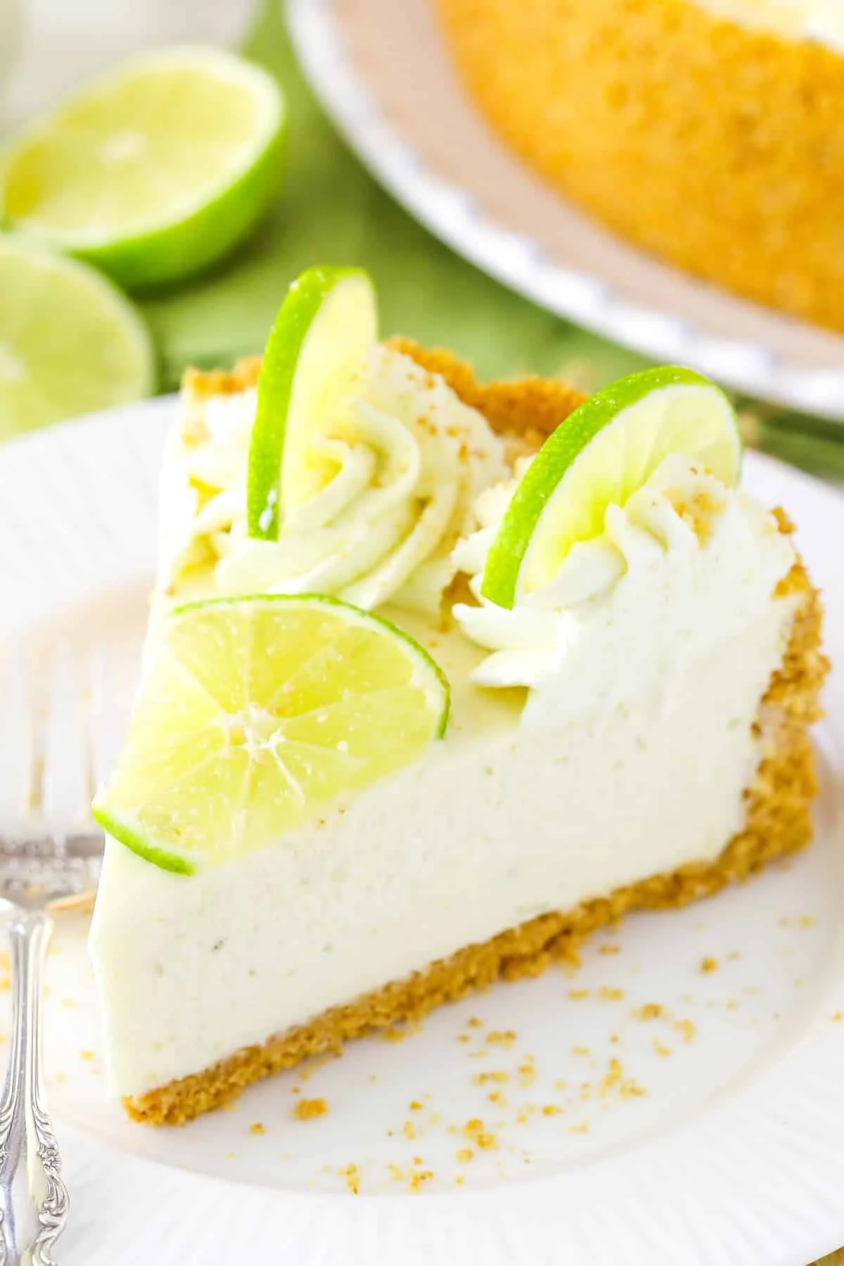 No Bake Key Lime Cheesecake topped with lime slices and whipped cream