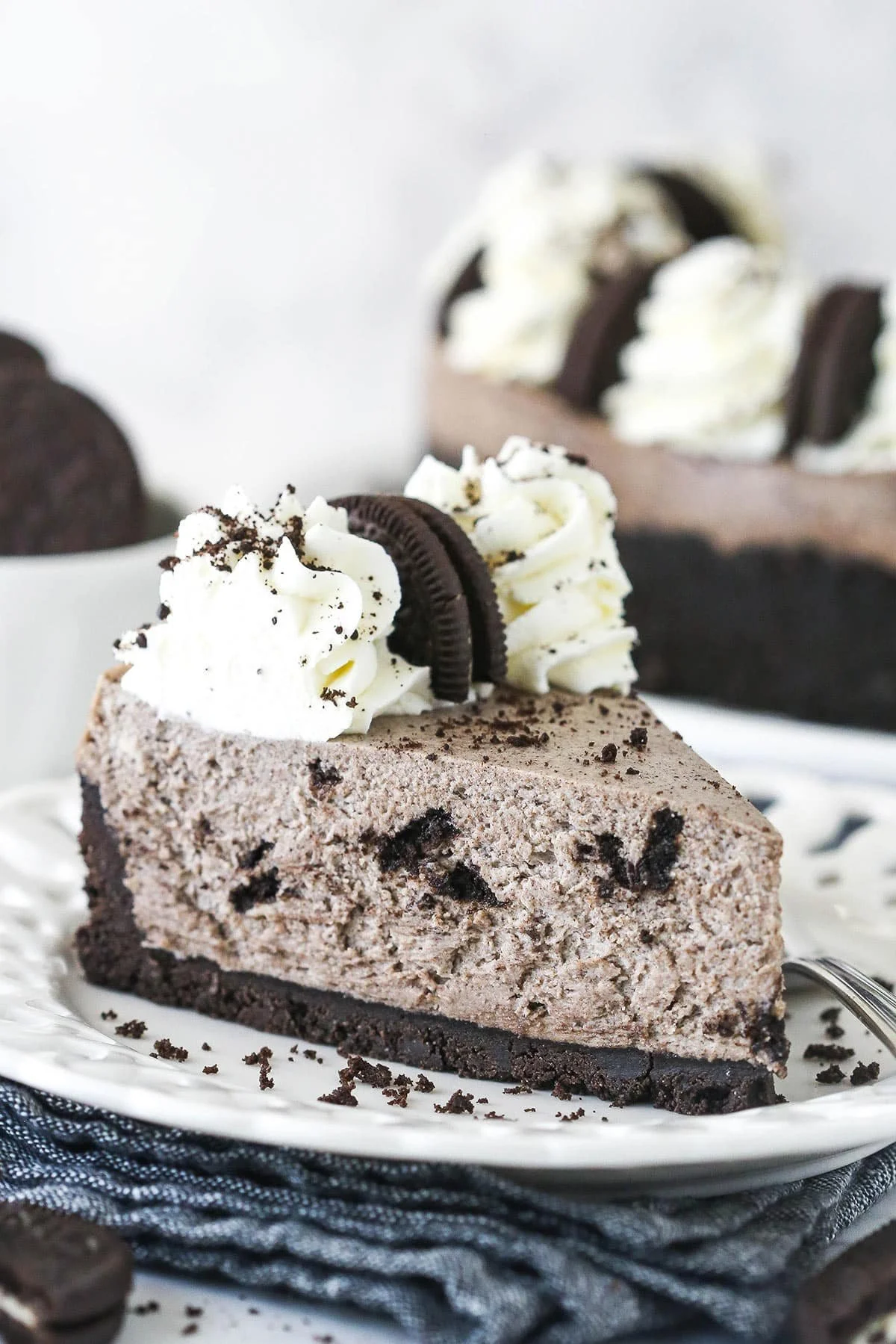 Delicious No Bake Oreo Cheesecake topped with crushed Oreos and whipped cream