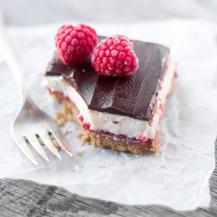 Delicious no bake raspberry cheesecake bars served on a plate
