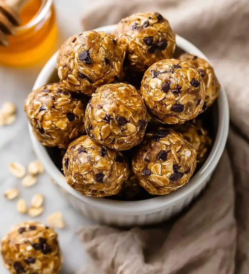 Healthy no-bake oatmeal energy balls piled on a plate.