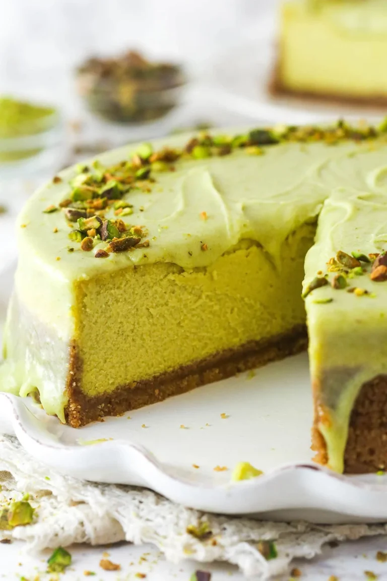 Delicious slice of pistachio cheesecake garnished with pistachios and whipped cream