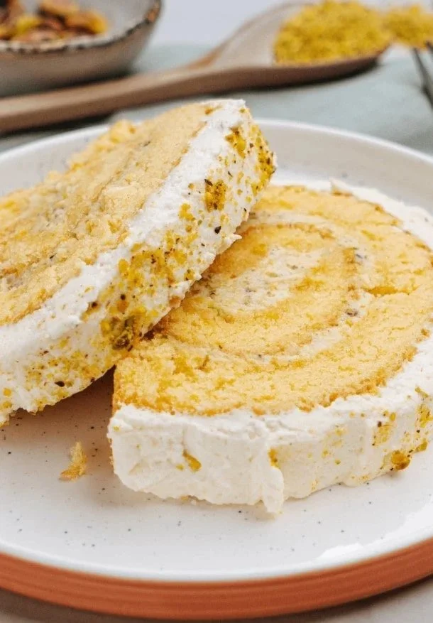 Pistachio Lemon Roll Cake with cream filling and pistachio garnish