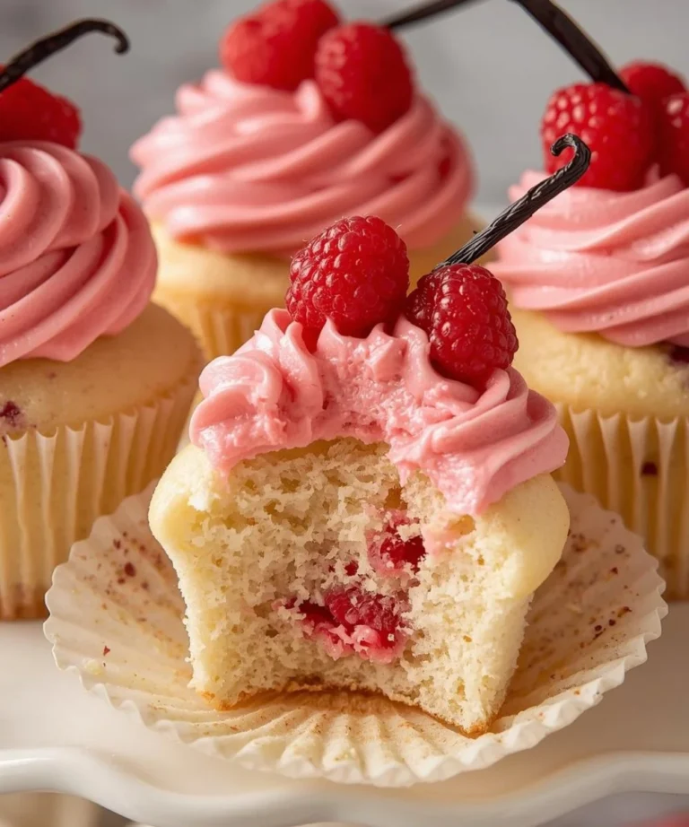 Delicious Raspberry Vanilla Bean Cupcakes decorated with fresh raspberries.