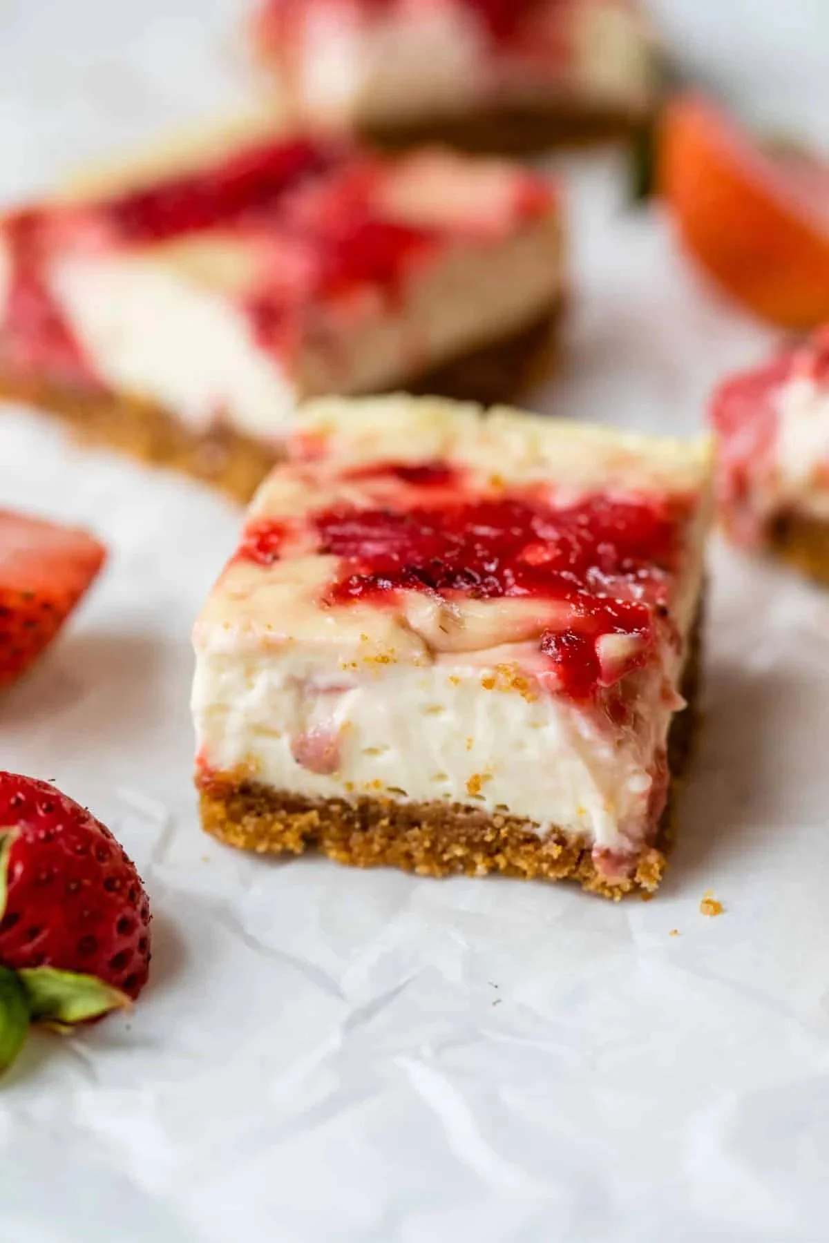 Delicious strawberry cheesecake bars topped with fresh strawberries