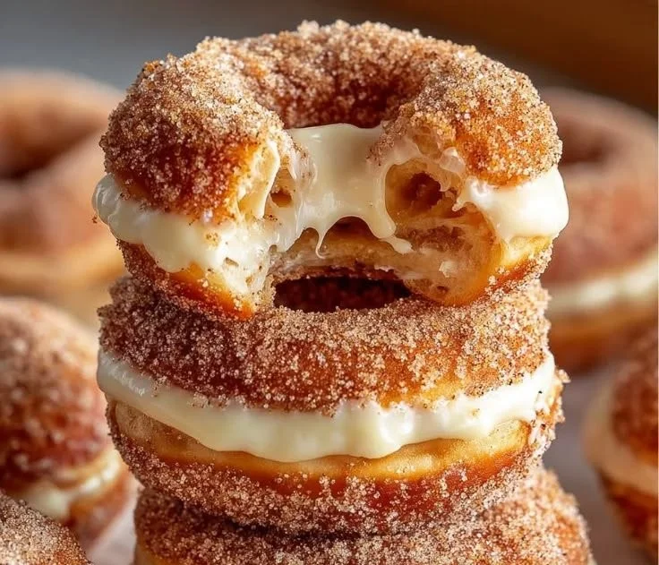 Cinnamon kissed cheesecake donut cookies on a plate with sprinkles