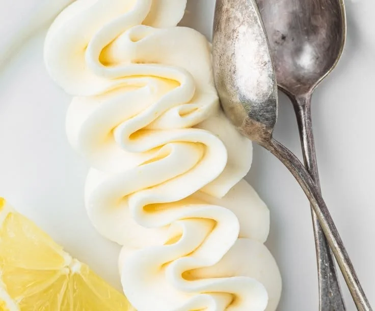 Lemon buttercream frosting spread on a delicious cake