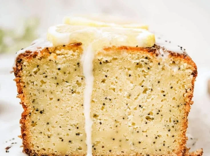 Moist lemon poppy seed cake with a sprinkle of poppy seeds on top