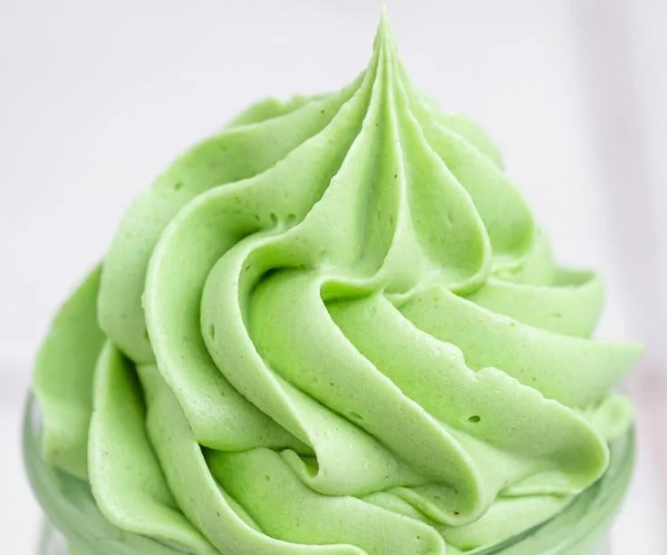 A bowl of creamy Pistachio Buttercream frosting ready for cake decoration