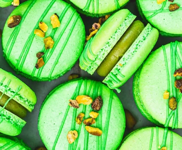 Elegant pistachio macarons displayed on a decorative plate
