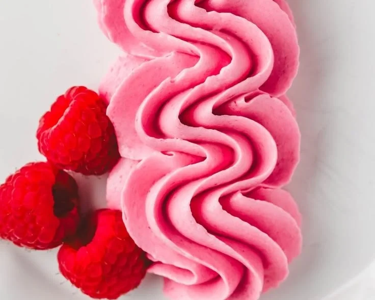 Delicious Raspberry Buttercream Frosting on a decadent cupcake.