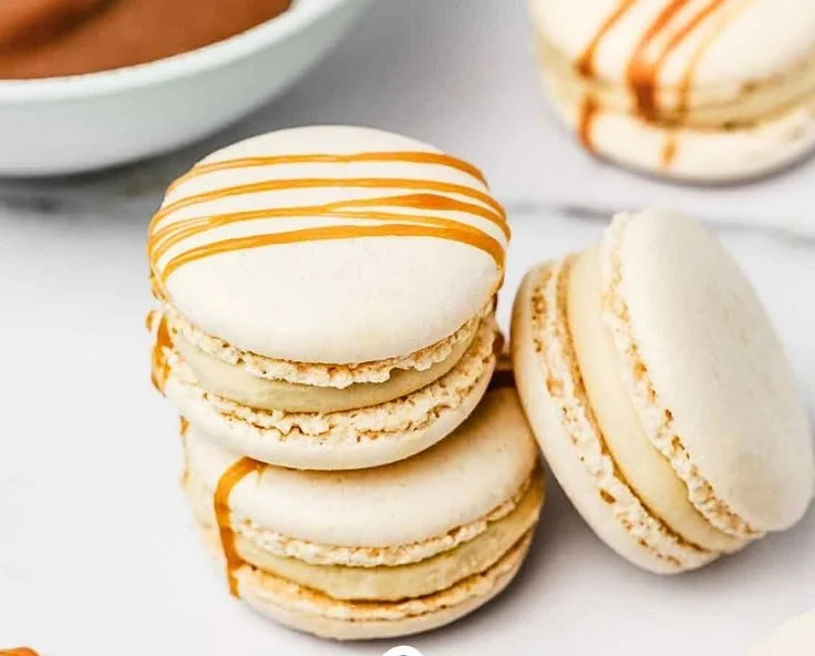 Delicious Salted Caramel Macarons displayed on a dessert table.