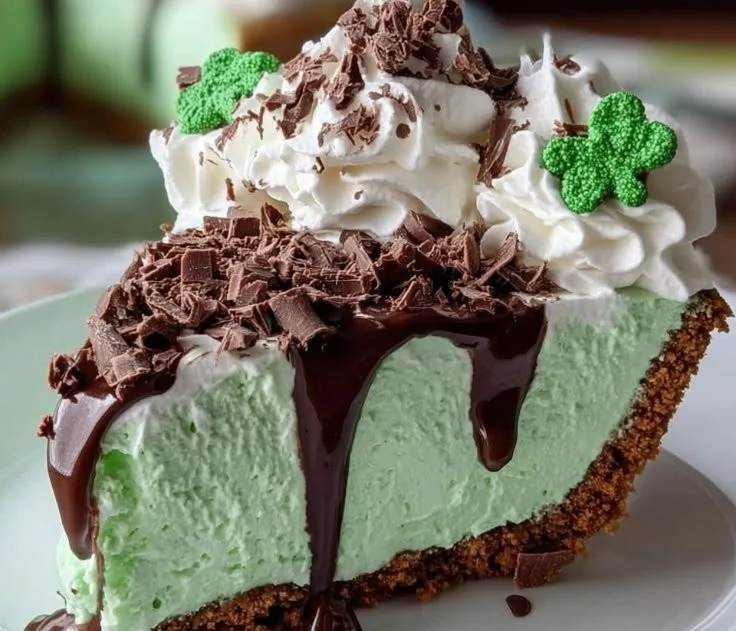 Slice of super easy pistachio cream pie topped with whipped cream and pistachios
