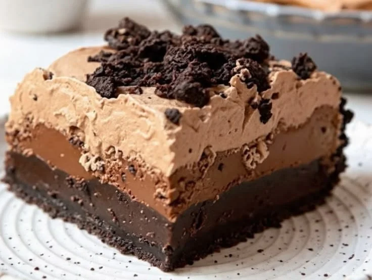 Delicious slice of Chocolate Mud Pie topped with whipped cream and chocolate shavings.